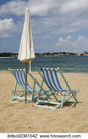 Stock Image - "Deck chairs on the sandy beach of Saint-Jean-de-Luz, French Atlantic Coast, Aquitaine, Departement Pyrenees-Atlantiques, France, Europe". Fotosearch
