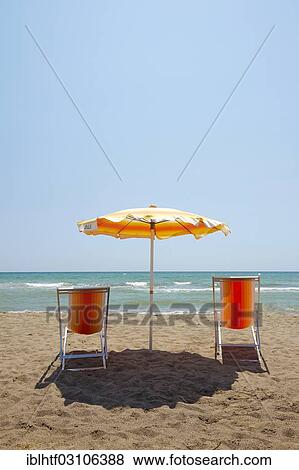 "Deckchairs and a sun umbrella on a sandy beach, Maremma, Italy, Europe" View Large Photo Image Stock Photo - "Deckchairs and a sun umbrella on a sandy beach, Maremma, Italy, Europe". Fotosearch