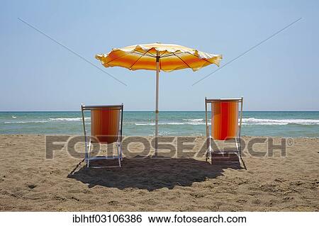 "Deckchairs and a sun umbrella on a sandy beach, Maremma, Italy, Europe" View Large Photo Image Stock Photograph - "Deckchairs and a sun umbrella on a sandy beach, Maremma, Italy, Europe". Fotosearch
