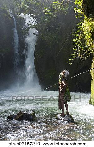 "Decorated and painted tribal chief standing in front of a waterfall in the Highlands, Paya, Highland, Papua New Guinea, Oceania" View Large Photo Image Stock Image - "Decorated and painted tribal chief standing in front of a waterfall in the Highlands, Paya, Highland, Papua New Guinea, Oceania". Fotosearch