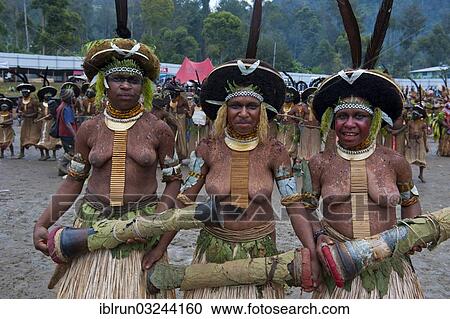 Stock Image - "Decorated and painted women celebrating the traditional Sing Sing in the highlands, Enga, Highlands, Papua New Guinea, Oceania". Fotosearch
