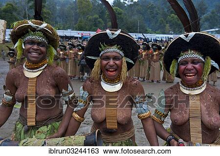 Stock Image - "Decorated and painted women celebrating the traditional Sing Sing in the highlands, Enga, Highlands, Papua New Guinea, Oceania". Fotosearch