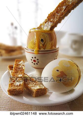Decorated festive Easter eggs being eaten for breakfast View Large Photo Image Stock Photo - Decorated festive Easter eggs being eaten for breakfast. Fotosearch