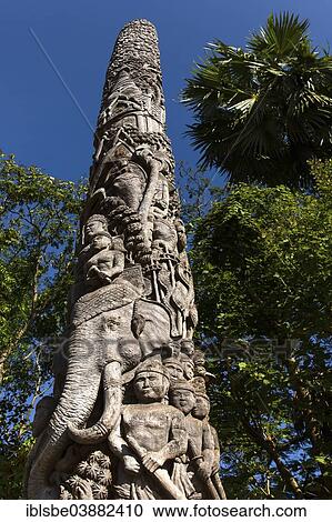 Stock Image - "Decorative wooden pillar in the courtyard of Wat Doi Ngam Muang, carved teak totem, Chiang Rai, Chiang Rai province, Northern Thailand, Thailand, Asia". Fotosearch