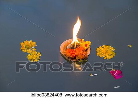 "Deepak, a religious instrument with the meaning of the source of light, is swimming in the holy river Godwari, Trimbak, Maharashtra, India, Asia" View Large Photo Image Stock Photo - "Deepak, a religious instrument with the meaning of the source of light, is swimming in the holy river Godwari, Trimbak, Maharashtra, India, Asia". Fotosearch