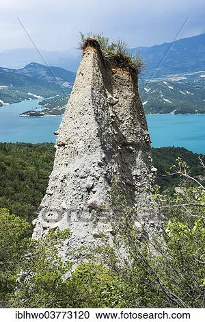 "Demoiselles Coiffee, earth pyramids, Lac de Serre-Poncon reservoir at back, Departement Hautes-Alpes, Provence-Alpes-Cote d'Azur, France, Europe" View Large Photo Image Stock Image - "Demoiselles Coiffee, earth pyramids, Lac de Serre-Poncon reservoir at back, Departement Hautes-Alpes, Provence-Alpes-Cote d'Azur, France, Europe". Fotosearch
