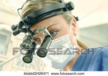 "Dentist, dental hygienist, wearing a face mask and magnifying loupes" View Large Photo Image Stock Image - "Dentist, dental hygienist, wearing a face mask and magnifying loupes". Fotosearch