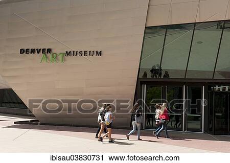 Stock Image - "Denver Art Museum, Hamilton Building, young woman at the entrance, Denver, Colorado, USA". Fotosearch