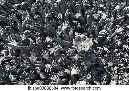 Picture - "Depiction of hell, hands pleading for help at Wat Rong Khun, bridge to the entrance of the White Temple, by architect Chalermchai Kositpipat, Chiang Rai, Chiang Rai Province, Northern Thailand, Thailand, Asia". Fotosearch