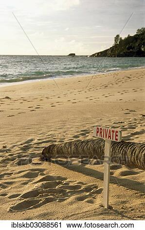 Stock Image - "Deserted sandy beach with a wooden sign, """"private"""", Mahe, Seychelles, Africa". Fotosearch
