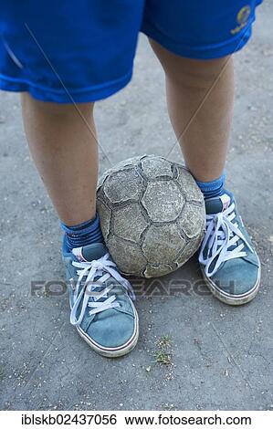 Detailed view of children legs with an old football View Large Photo Image Stock Photograph - Detailed view of children legs with an old football. Fotosearch