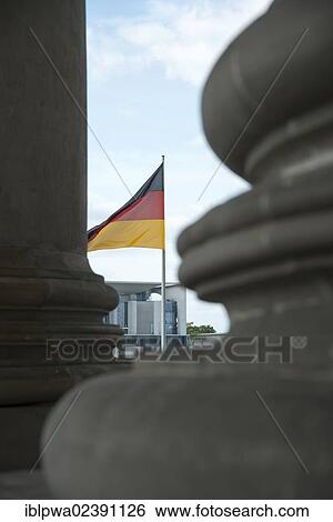 "Details of columns in front of the Reichstag Building with the German flag and looking towards the Federal Chancellery in Berlin, Germany, Europe" View Large Photo Image Stock Photograph - "Details of columns in front of the Reichstag Building with the German flag and looking towards the Federal Chancellery in Berlin, Germany, Europe". Fotosearch