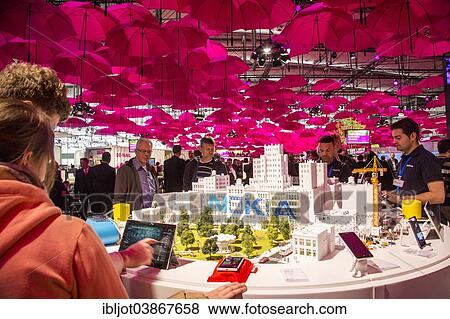 Stock Photo - "Deutsche Telekom stand, many pink umbrellas forming a roof over the stand, computer fair CeBIT 2014, Hanover, Lower Saxony, Germany, Europe". Fotosearch