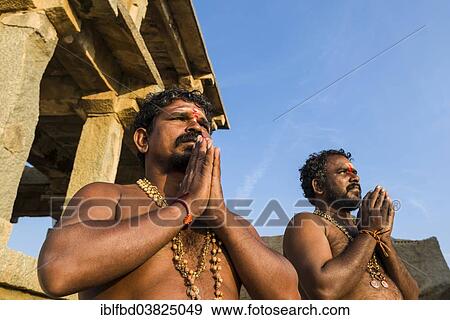 "Devotees praying at a temple on Hemakuta Hill, ruined city of Vijayanagara, UNESCO World Heritage Site, Hampi, Karnataka, India, Asia" View Large Photo Image Stock Photo - "Devotees praying at a temple on Hemakuta Hill, ruined city of Vijayanagara, UNESCO World Heritage Site, Hampi, Karnataka, India, Asia". Fotosearch