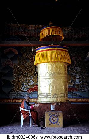 "Devout Buddhist praying at a prayer wheel in Punakha Dzong, Punakha, Punakha district, Bhutan, Asia" View Large Photo Image Stock Photo - "Devout Buddhist praying at a prayer wheel in Punakha Dzong, Punakha, Punakha district, Bhutan, Asia". Fotosearch