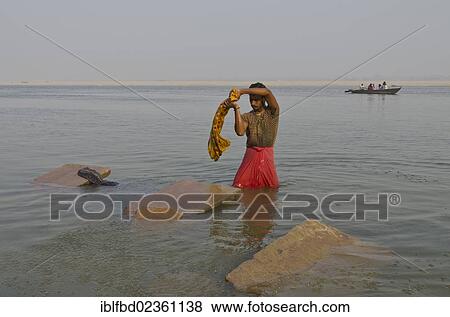 "Dhobi wala, a member of the laundry cast, doing his daily work at the ghats of Varanasi along the holy river Ganges, India, Asia" View Large Photo Image Stock Photo - "Dhobi wala, a member of the laundry cast, doing his daily work at the ghats of Varanasi along the holy river Ganges, India, Asia". Fotosearch