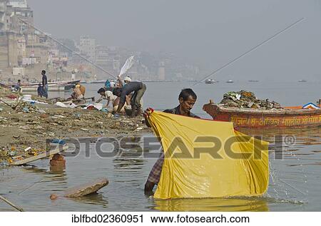 "Dhobi walas, people of the laundry caste, doing their daily work at the ghats of Varanasi along the holy river Ganges, India, Asia" View Large Photo Image Stock Image - "Dhobi walas, people of the laundry caste, doing their daily work at the ghats of Varanasi along the holy river Ganges, India, Asia". Fotosearch