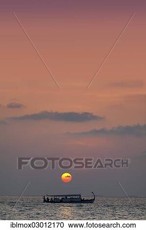 Stock Image - "Dhoni, a Maldivian boat, on the sea before sunset, Indian Ocean, Male, North Male Atoll, Maldives, Asia". Fotosearch