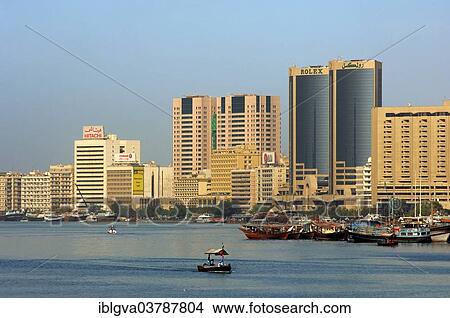 "Dhows, traditional ships in the port at Dubai Creek in front of modern skyscrapers, Dubai, United Arab Emirates, Asia" View Large Photo Image Picture - "Dhows, traditional ships in the port at Dubai Creek in front of modern skyscrapers, Dubai, United Arab Emirates, Asia". Fotosearch