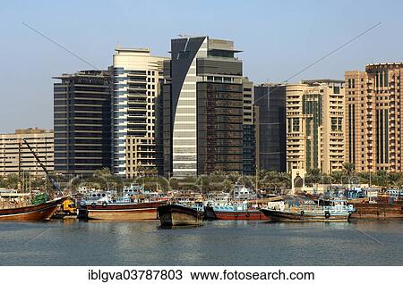 "Dhows, traditional ships in the port at Dubai Creek in front of modern skyscrapers, Dubai, United Arab Emirates, Asia" View Large Photo Image Stock Image - "Dhows, traditional ships in the port at Dubai Creek in front of modern skyscrapers, Dubai, United Arab Emirates, Asia". Fotosearch