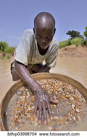 Picture - "Diamond hunter searching for diamonds with a sieve, near Koidu, Koidu-Sefadu, Kono District, Eastern Province, Sierra Leone, Africa". Fotosearch