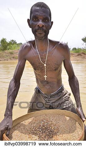 "Diamond hunter searching for diamonds with a sieve, near Koidu, Koidu-Sefadu, Kono District, Eastern Province, Sierra Leone, Africa" View Large Photo Image Stock Photo - "Diamond hunter searching for diamonds with a sieve, near Koidu, Koidu-Sefadu, Kono District, Eastern Province, Sierra Leone, Africa". Fotosearch