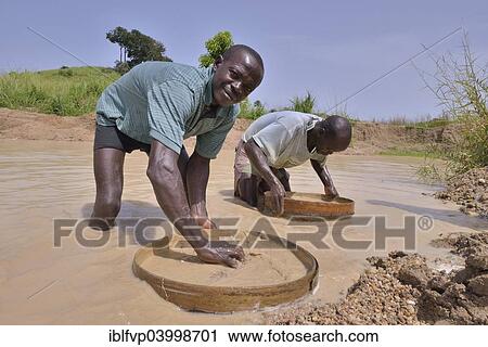 "Diamond hunters searching for diamonds in a mine with sieves, near Koidu, Koidu-Sefadu, Kono District, Eastern Province, Sierra Leone, Africa" View Large Photo Image Stock Image - "Diamond hunters searching for diamonds in a mine with sieves, near Koidu, Koidu-Sefadu, Kono District, Eastern Province, Sierra Leone, Africa". Fotosearch