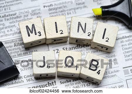 Stock Photograph - Dice spelling out the word Mini Job, on newspaper classifieds, symbolic image for mini jobs. Fotosearch