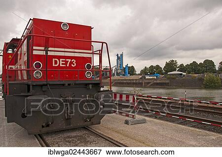 Stock Photo - "Diesel-hydraulic locomotive, for routes and shunting with electric power transmission in AC Transmission, manufacturer MAK Kiel and ABB Mannheim, DE 1002 series, built in 1990, Westkai terminal, Cologne Niehl, North Rhine-Westphalia, Germany, Europe". Fotosearch