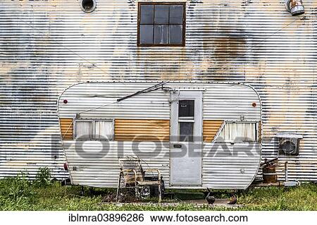 "Dilapidated caravan made of corrugated iron parked in front of a corrugated iron wall, rusty chair at the front, Clarksdale, Mississippi, United States, North America" View Large Photo Image Stock Photograph - "Dilapidated caravan made of corrugated iron parked in front of a corrugated iron wall, rusty chair at the front, Clarksdale, Mississippi, United States, North America". Fotosearch