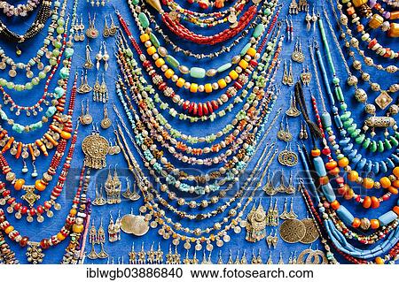 Stock Image - "Display of various necklaces and earrings with glass beads and traditional Arab and Berber patterns, on sale at the souk or bazaar, Marrakech, Morocco, Africa". Fotosearch