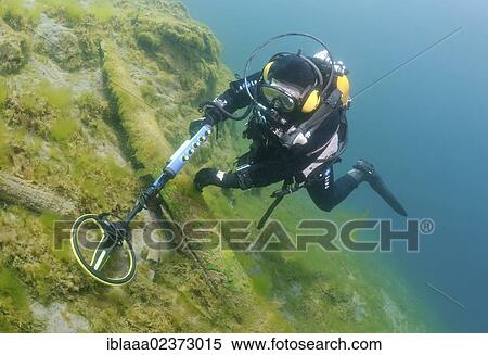 Stock Photography - "Diver with the metal detector looks for a treasure under water, lake Baikal, Siberia, Russia, Eurasia, Europe". Fotosearch