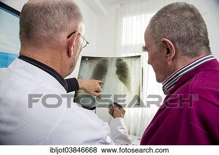 "Doctor's office, doctor talking to an elderly patient about the x-ray image of a lung, Germany, Europe" View Large Photo Image Stock Photo - "Doctor's office, doctor talking to an elderly patient about the x-ray image of a lung, Germany, Europe". Fotosearch