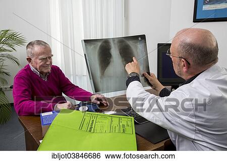 "Doctor's office, doctor talking to an elderly patient about the x-ray image of a lung, Germany, Europe" View Large Photo Image Stock Photograph - "Doctor's office, doctor talking to an elderly patient about the x-ray image of a lung, Germany, Europe". Fotosearch