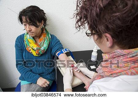 "Doctor's office, patient gets her blood taken by a doctor's assistant, Germany, Europe" View Large Photo Image Picture - "Doctor's office, patient gets her blood taken by a doctor's assistant, Germany, Europe". Fotosearch