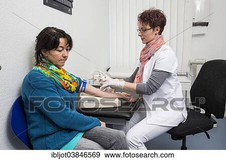 "Doctor's office, patient gets her blood taken by a doctor's assistant, Germany, Europe" View Large Photo Image Stock Photo - "Doctor's office, patient gets her blood taken by a doctor's assistant, Germany, Europe". Fotosearch