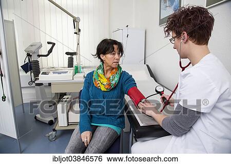"Doctor's office, patient gets her blood pressure taken by a doctor's assistant, Germany, Europe" View Large Photo Image Stock Photograph - "Doctor's office, patient gets her blood pressure taken by a doctor's assistant, Germany, Europe". Fotosearch