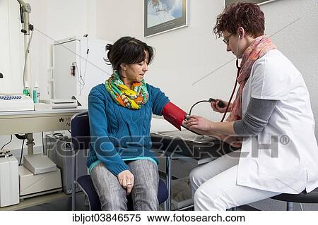 "Doctor's office, patient gets her blood pressure taken by a doctor's assistant, Germany, Europe" View Large Photo Image Stock Photography - "Doctor's office, patient gets her blood pressure taken by a doctor's assistant, Germany, Europe". Fotosearch