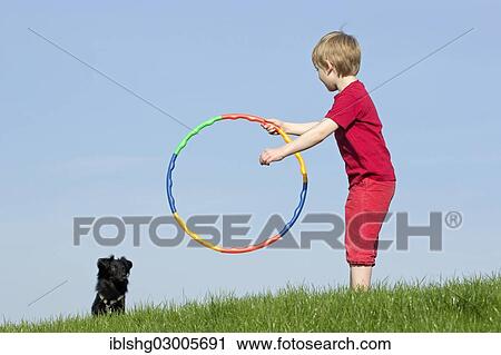 "Dog training, boy encouraging a dog to jump through a hoop, Wilhelmsburg, Hamburg, Hamburg, Germany, Europe" View Large Photo Image Stock Image - "Dog training, boy encouraging a dog to jump through a hoop, Wilhelmsburg, Hamburg, Hamburg, Germany, Europe". Fotosearch