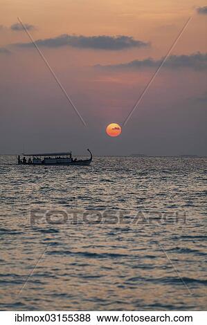 Stock Photo - "Dohni, a Maldivian boat at sunset, Indian Ocean, Male, North Male Atoll, Maldives, Asia". Fotosearch