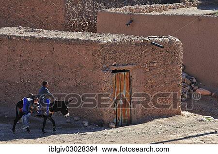 Picture - "Donkey riders in the Kasbah Tamnougalt near Agdz, Draatal, Tamnougalt, Souss-Massa-Draa region, Morocco, Africa". Fotosearch
