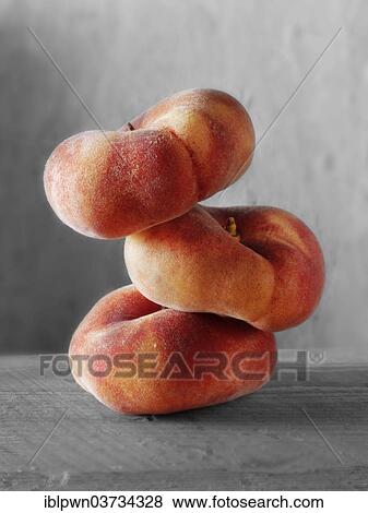 Donut peaches piled on top of each other View Large Photo Image Stock Photo - Donut peaches piled on top of each other. Fotosearch