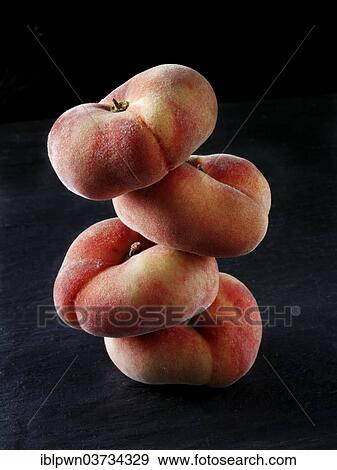 Stock Photo - Donut peaches piled on top of each other. Fotosearch