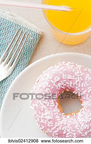 Donut with sprinkles and a glass of orange soda View Large Photo Image Stock Photo - Donut with sprinkles and a glass of orange soda. Fotosearch