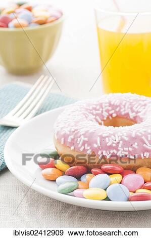 Donut with sprinkles and a glass of orange soda View Large Photo Image Stock Photo - Donut with sprinkles and a glass of orange soda. Fotosearch