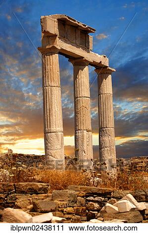 Stock Image - "Doric columns of the Temple of Poseidon, the ruins of the Greek city of Delos, the birthplace of the twin gods Apollo and Artemis, Cyclades Islands, Greece, Europe". Fotosearch