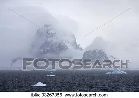 "Dorsey Mountains shrouded with clouds, Smith Peninsula, Antarctic Peninsula, Antarctica" View Large Photo Image Stock Photograph - "Dorsey Mountains shrouded with clouds, Smith Peninsula, Antarctic Peninsula, Antarctica". Fotosearch