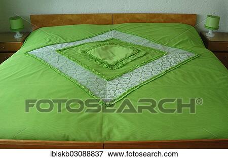 Double bed with a green bedspread View Large Photo Image Stock Photo - Double bed with a green bedspread. Fotosearch