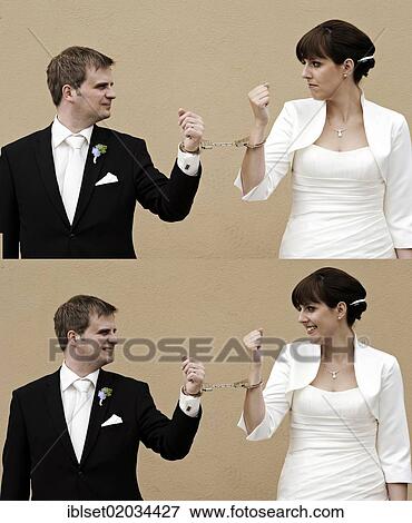 "Double image of a wedding couple connected with handcuffs, the bride and groom looking at each other, first seriously and then laughing, marriage" View Large Photo Image Stock Photo - "Double image of a wedding couple connected with handcuffs, the bride and groom looking at each other, first seriously and then laughing, marriage". Fotosearch