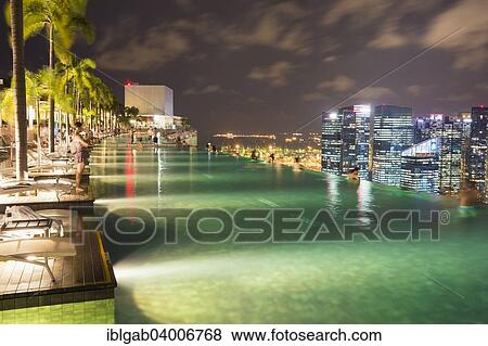 "Downtown central financial district at night viewed from the Infinity pool of the Marina Bay Sands, Singapore, Asia" View Large Photo Image Stock Photo - "Downtown central financial district at night viewed from the Infinity pool of the Marina Bay Sands, Singapore, Asia". Fotosearch